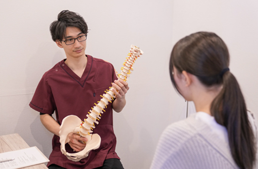 骨格模型を使って症状を説明するカウンセリングの様子